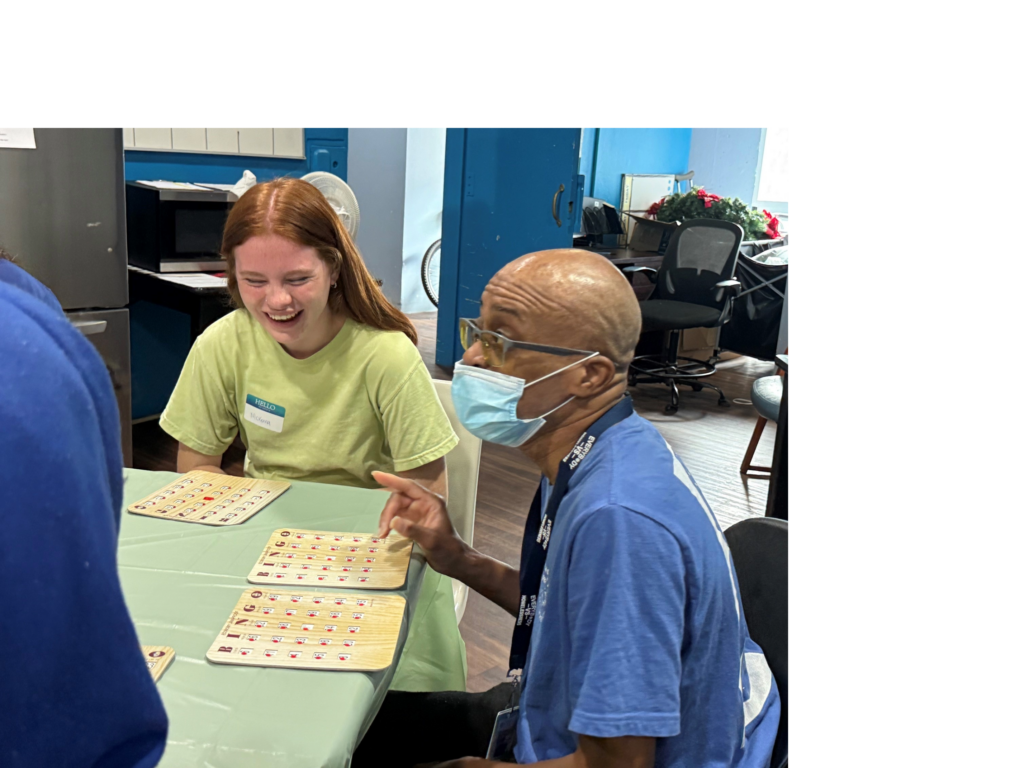 teen laughing with man while playing bingo
