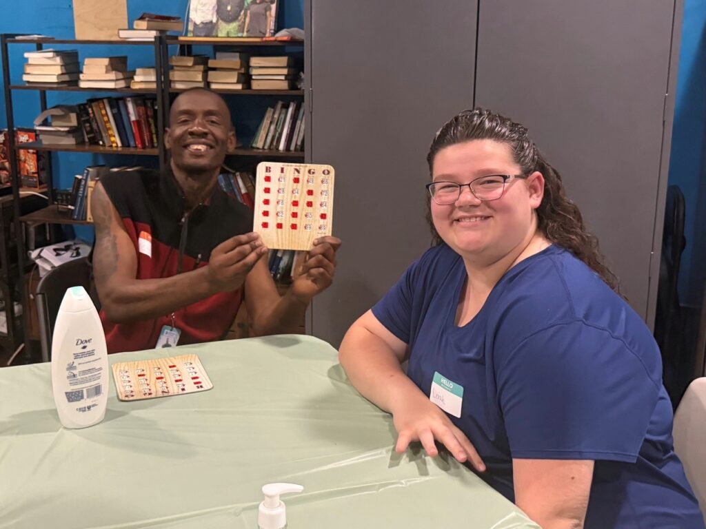 volunteer playing bingo with recuperative care patient